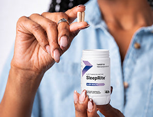 Woman holding a 4Life SleepRite capsule and bottle